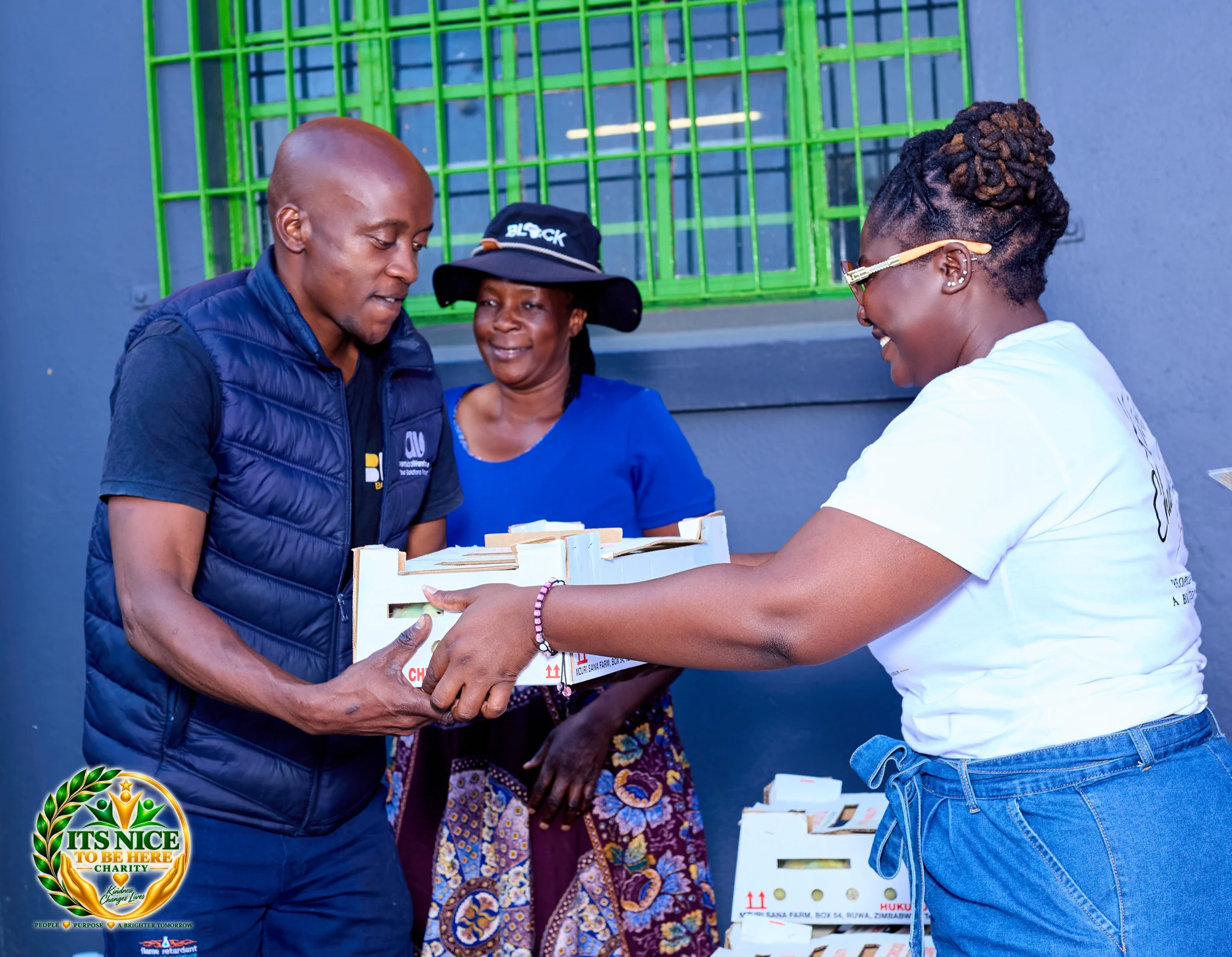 A participant receiving a box of chicks at the Harare outreach