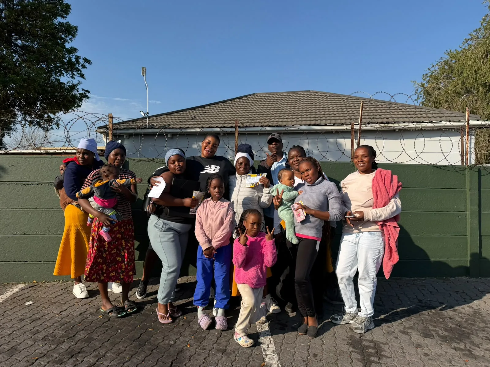 Community members standing together outdoors in a photograph from the relocation initiative